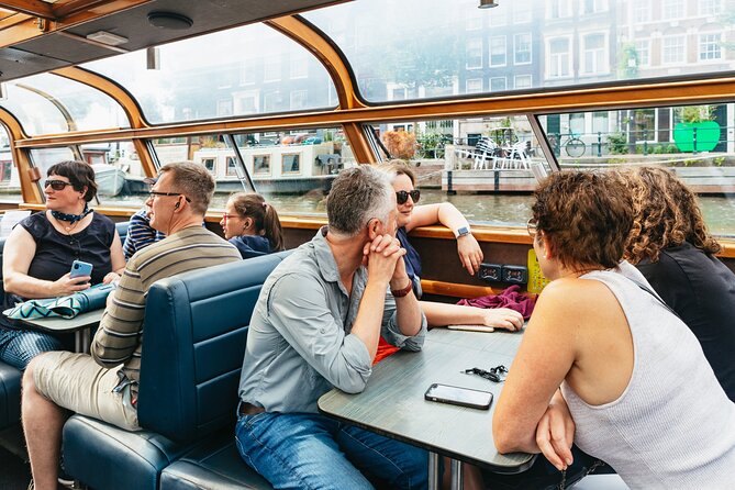 Amsterdam City Centre Cruise on heated boat with Audioguide - Boarding near Centraal Station, Damrak, or the museums