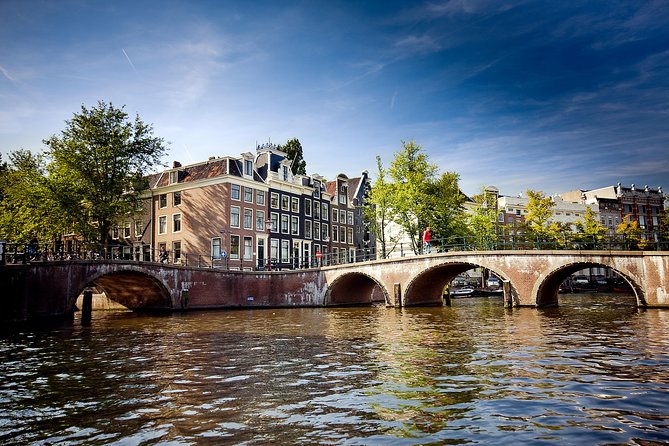 Amsterdam City Centre Cruise on heated boat with Audioguide - Audio commentary, captains, and the onboard atmosphere