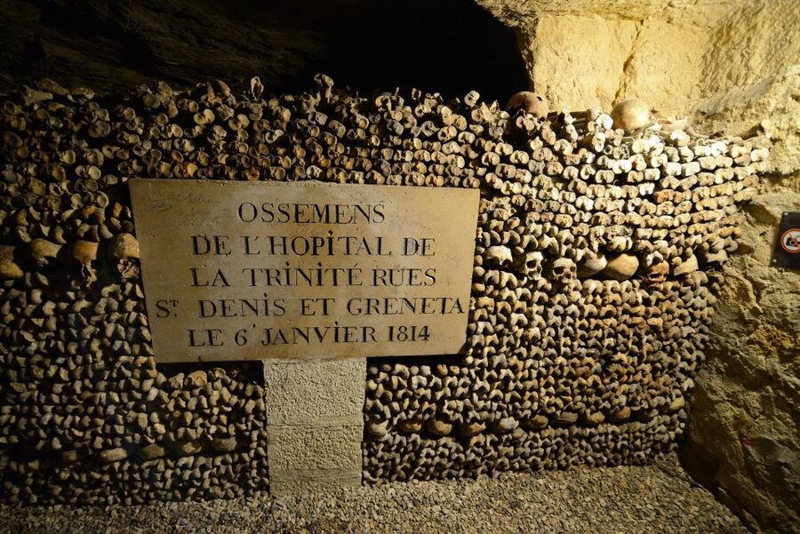 Paris: Catacombs Entry & Seine River Cruise with Audio Guide - Walking through the 14°C underground tunnels